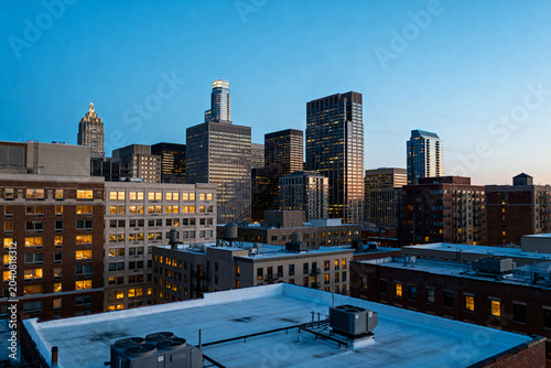 Urban cityscape with illuminated office buildings at dusk