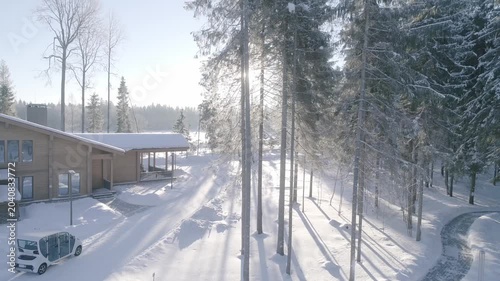 Drone smoothly ascending in snowy woods