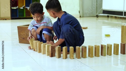 Children playing with wooden blocks in a classroom video footage