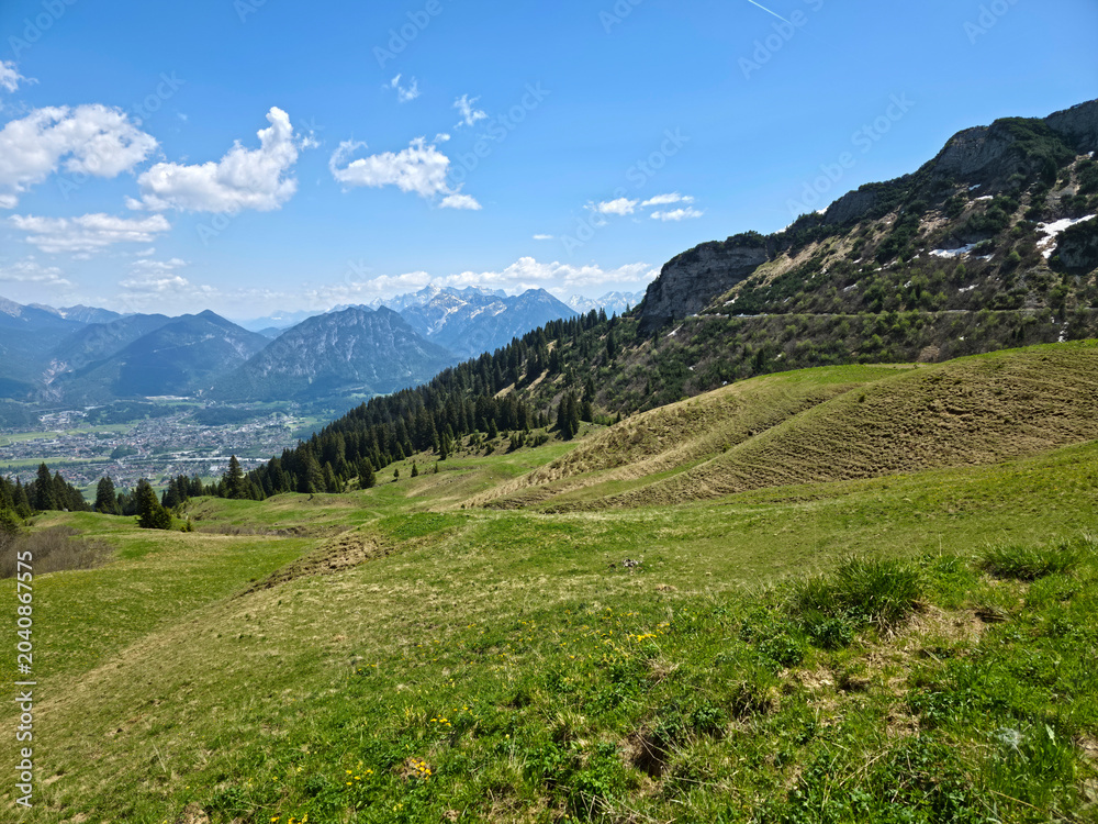 Naklejka premium Austria, Magnificent alpine mountain landscape featuring snow peaks green pastures hiking routes and crystal skies on hahnenkamm