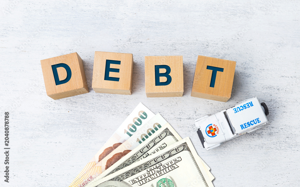 Φωτογραφία Debt on wooden cube with bank note and rescue toy car on white background, finan
