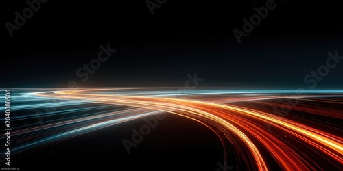 Streaking lights of orange and blue form abstract lines on a dark background
