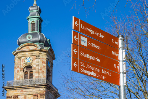 Tourist sign near the tower of Basilica of St. John in Saarbrucken