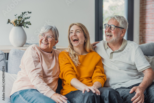 фотографія Three generations of a happy family, including a young woman and her senior pare