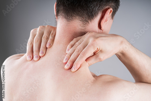 Man suffering from neck and shoulder pain. Massaging tense trapezius muscle. Office syndrome and backache medical concept