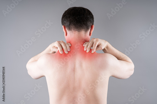 Man suffering from neck and shoulder pain. Massaging tense trapezius muscle. Office syndrome and backache medical concept