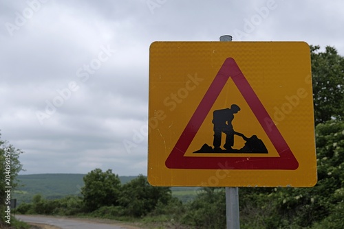 Bild auf Leinwand Yellow men at work sign warning on rural road