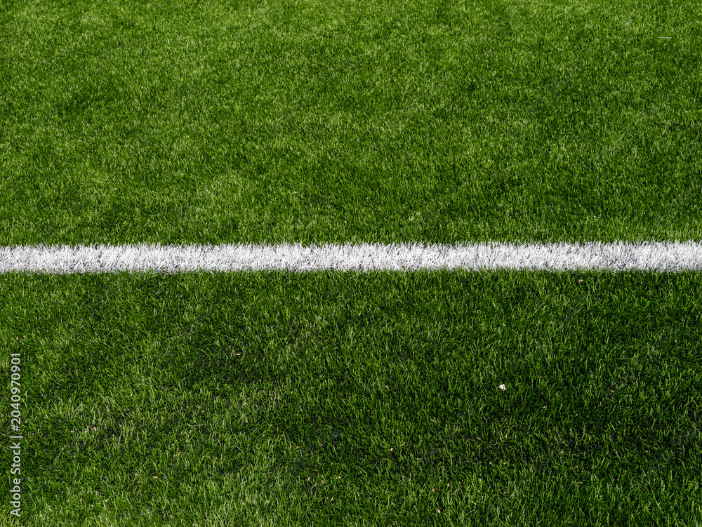 Naklejka premium White sideline on dark green soccer pitch