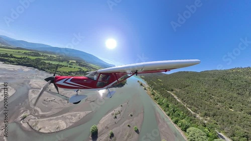 External airplane view flying at low altitude over Alpine Lake and mountains, Southern France