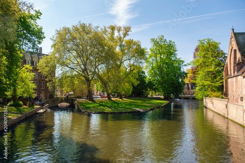 Morning view of canals and historic houses in Bruges