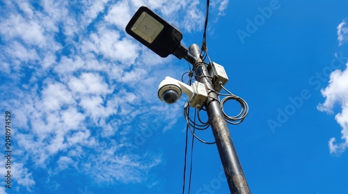 Security camera and street light on a pole