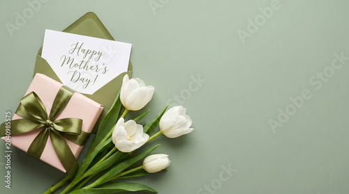 Elegant Happy Mother's Day Greeting Card, Pink Gift Box, and White Tulips on a Green Background.