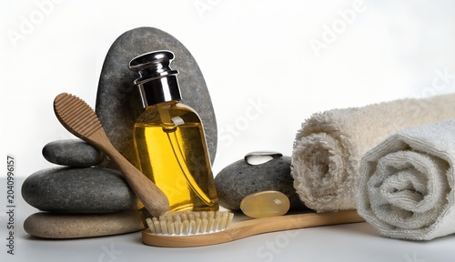 Spa essentials with massage stones, oil, and towel for relaxation