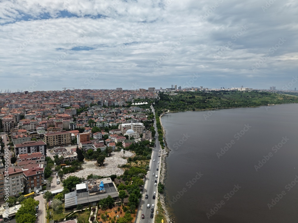 Fototapeta premium Panoramic Aerial Cityscape Under a Dramatic Cloudy Sky