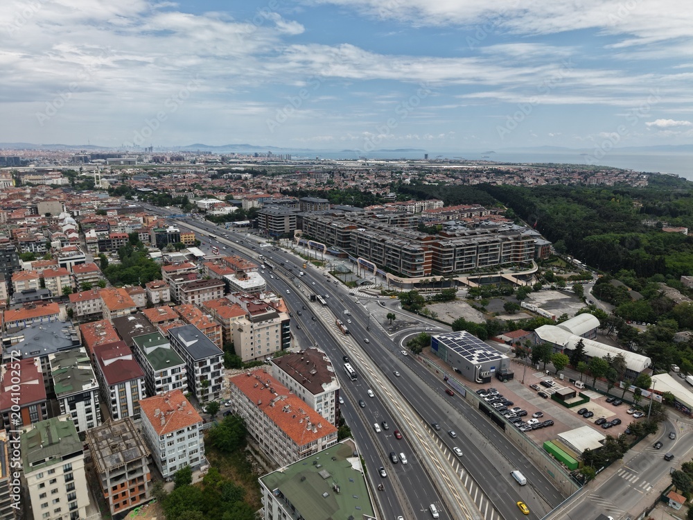 Obraz premium Panoramic Aerial Cityscape Under a Dramatic Cloudy Sky