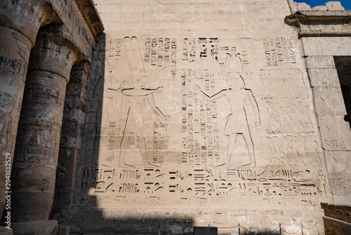 Photography The art  of ancient Egyptian story telling with carvings, reliefs and Hieroglyphs, Medinet Habu, the ancient Egyptian Mortuary Temple of Ramesses III on the West Bank of The Nile, Luxor, Egypt