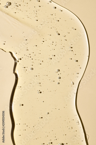 Viscous liquid serum spreading on a surface, highlighting its transparent gel texture and aeration bubbles