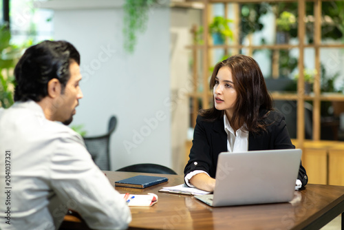 Happy young beautiful woman working and talking with customer at home office. saleswomen and businesswoman concept.