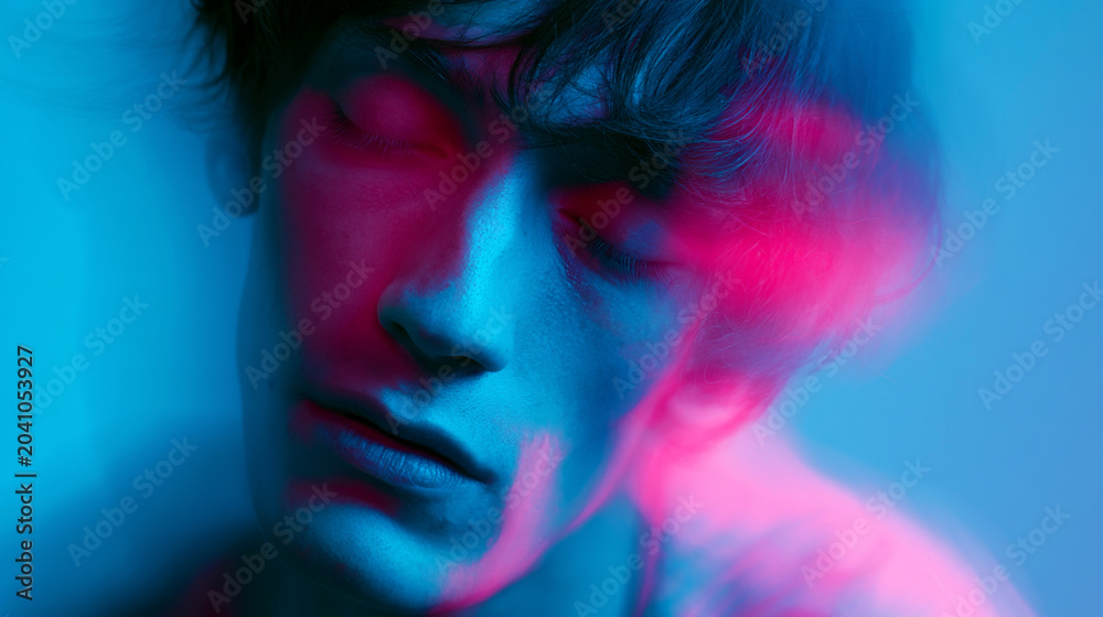 Fototapeta premium blurred portrait of intoxicated person in neon blue and pink light, surreal drunken face with psychedelic motion blur and abstract color distortion