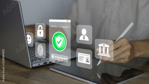 Verifying secure online banking login using two-factor authentication on a tablet and laptop, featuring verification status shield, fingerprint, padlock, user profile, ID, and bank icons