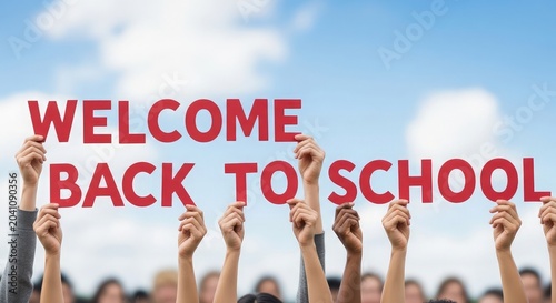 Welcome back to school diverse group of students holding up red letters under a bright blue sky with fluffy white clouds