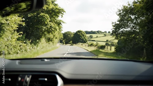 POV shot of car dashboard illustrating journey, adventure, and progress on a winding rural road