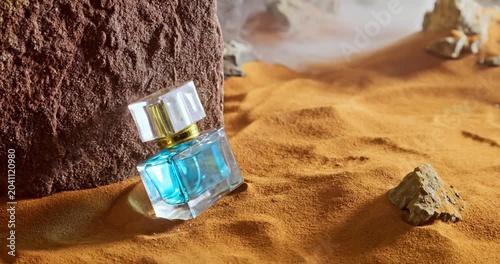 Unique amber perfumes in translucent glass bottle on sand.