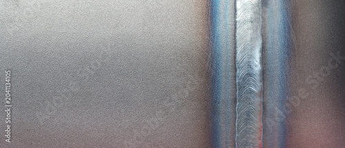 Fotografie A neat weld seam on a metal pipe, made with an automatic welding machine