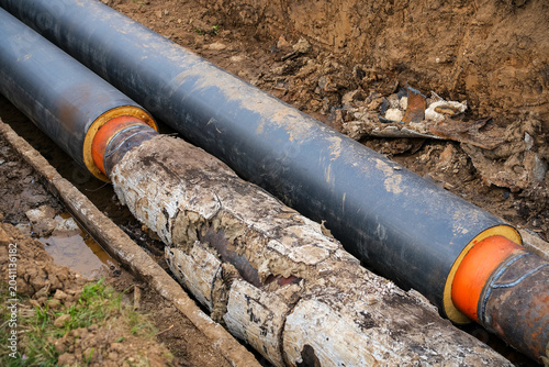Fotografie Old district heating pipes with outdated insulation being replaced by new insula