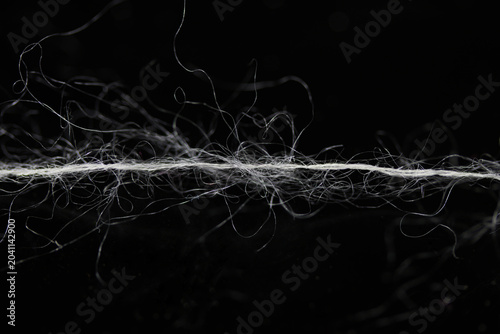 Canvastavla silk mohair yarn fiber on a black background, up close detail macro with shallow
