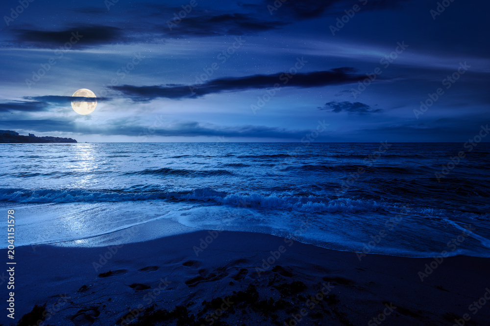 Fototapeta premium black sea landscape in summer at night. full moon over bulgaria nature landscape with sandy beach. mysterious summer vacation at the sea shore concept. waves and empty beach. remote vacation scene