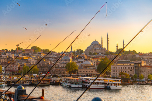 Obraz na płótnie Fishing rods framing Süleymaniye Mosque at sunset over Golden Horn in Istanbul T