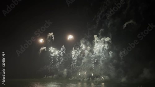 Spectacular fireworks burst in a kaleidoscope of colors against the darkened sky, captivating viewers during the local celebration. The explosions create a lively atmosphere filled with excitement.