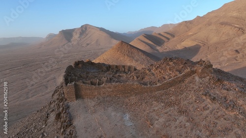 Photos Aerial View of Ancient Stone Ruins on Desert Mountain Ridge