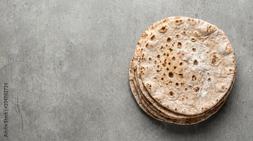 Stack of Fresh Flatbread on Grey Concrete Background 