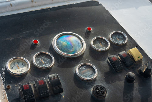 Vintage marine boat control dashboard panel gauges texture background craft close up.
