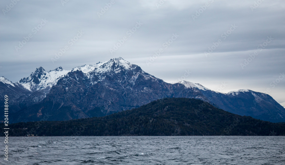 Fototapeta premium snow covered mountains Winter with snow on Lake Nahuel Huapi in San Carlos de Bariloche, Argentina.