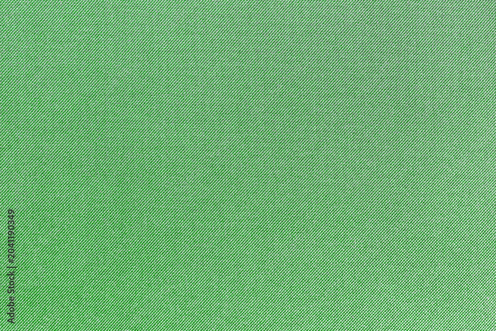 Fototapeta premium Green fabric texture background. Textile material closeup with diagonal weave pattern. Detailed cloth surface for fashion upholstery sewing and design projects with copy space