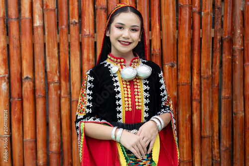 Portrait of young girl smiling wearing complete set of Dusun Tindal Clothes Sinipak during Kaamatan Harvest Festival