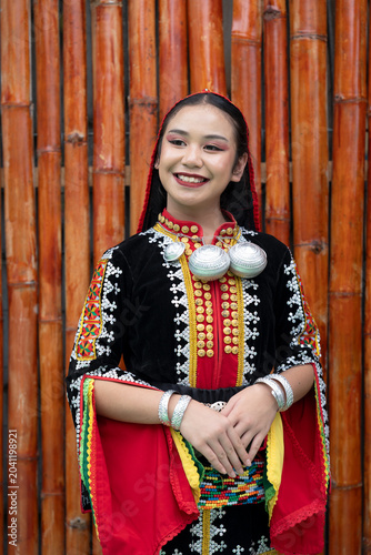 Portrait of young girl smiling wearing complete set of Dusun Tindal Clothes Sinipak during Kaamatan Harvest Festival