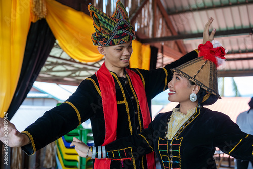 Portrait of young man and girl posing sumazau dancing in Kadazan Dusun Papr attire during Kaamatan Harvest Festival in Sabah