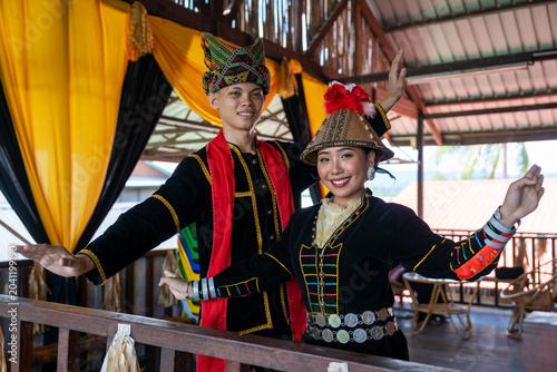 Portrait of young man and girl posing sumazau dancing in Kadazan Dusun Papr attire during Kaamatan Harvest Festival in Sabah
