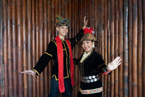 Portrait of young man and girl posing sumazau dancing in Kadazan Dusun Papr attire during Kaamatan Harvest Festival in Sabah