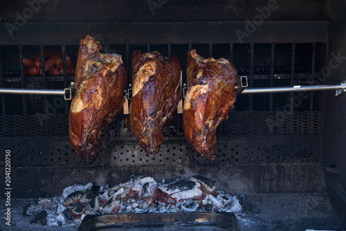 Canvastavla Roasting pork ham or knee on a spit over an open fire or coals