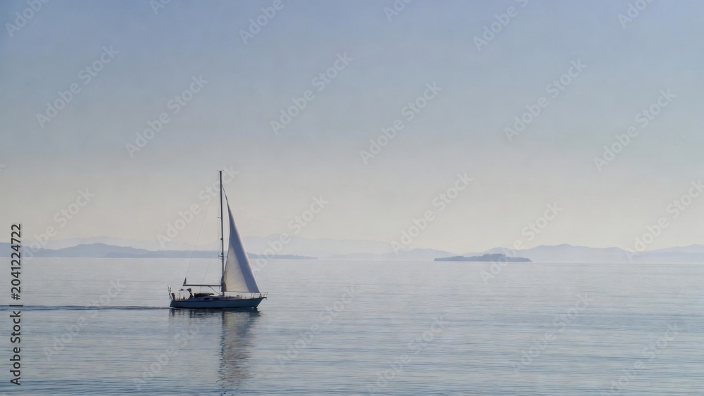 Fototapeta premium Sailboat gliding across calm sea with distant islands