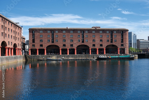 Obraz na płótnie Historic Royal Albert Dock red brick warehouses and boats reflected in water on
