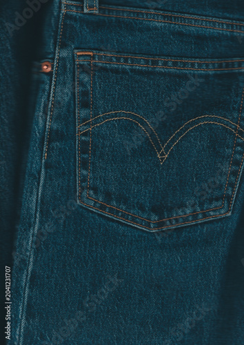 Dark blue denim jeans with a heart shape patch on the right leg