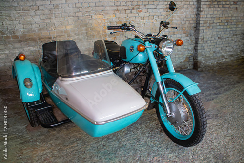 Fotografie Vintage motorcycle with sidecar parked indoors