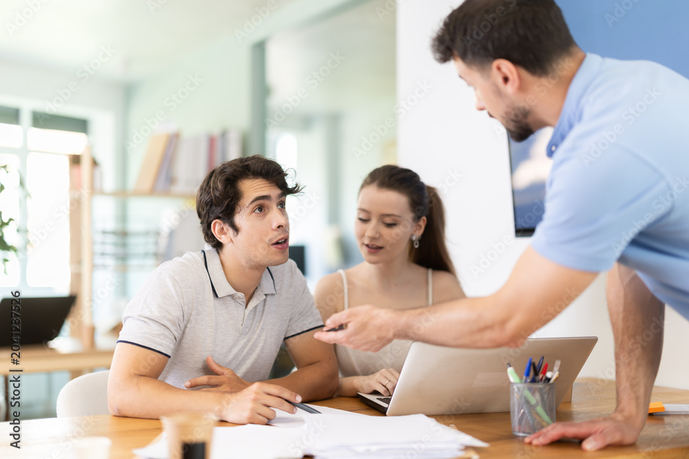 Fototapeta premium Three office employees read and process documents. Familiarization with contract, business correspondence, letter of claim, employment contract