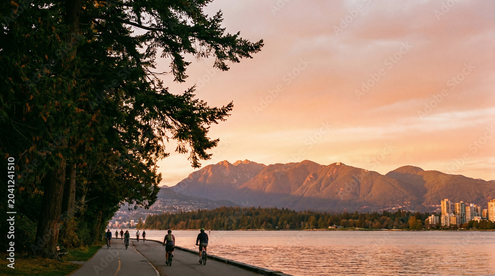 Fototapeta premium Vibrant Canadian landscapes bathed in the warm glow of a breathtaking sunset, showcasing serene waterfront activities and majestic mountain backdrops